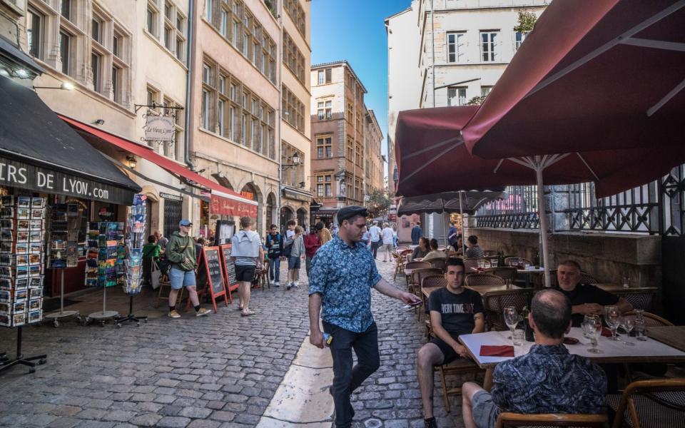 Tourists at a café terrace area in Lyon, France