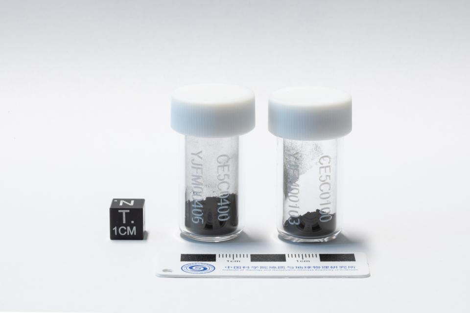 two glass vials containing grey dirt