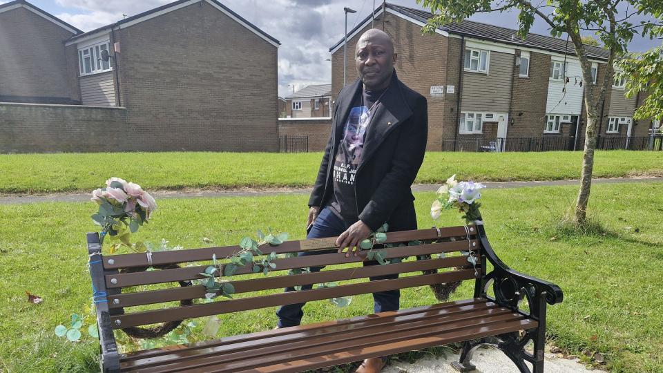 Mr Shani stands behind Nathaniel's bench