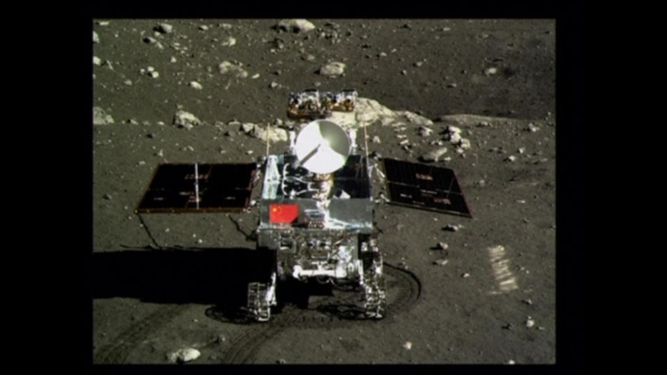 A view of China's first moon rover, Yutu, or Jade Rabbit, is seen on the lunar surface with the Chinese national flag in this still image taken from video provided by China Central Television (CCTV) December 16, 2013. China landed an unmanned spacecraft on the moon on Saturday, state media reported, in the first such "soft-landing" since 1976, joining the United States and the former Soviet Union in managing to accomplish such a feat. The Chang'e 3, a probe named after a lunar goddess in traditional Chinese mythology, is carrying the solar-powered Yutu buggy, which will dig and conduct geological surveys. (REUTERS/CCTV via Reuters TV)