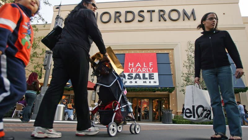 Shoppers are seen at the Grove shopping center in Los Angeles, Tuesday, Dec. 27, 2005. Shoppers armed with newly obtained gift cards and poorly received presents headed back to malls and stores in search of returns, post-Christmas discounts and fresh merchandise.