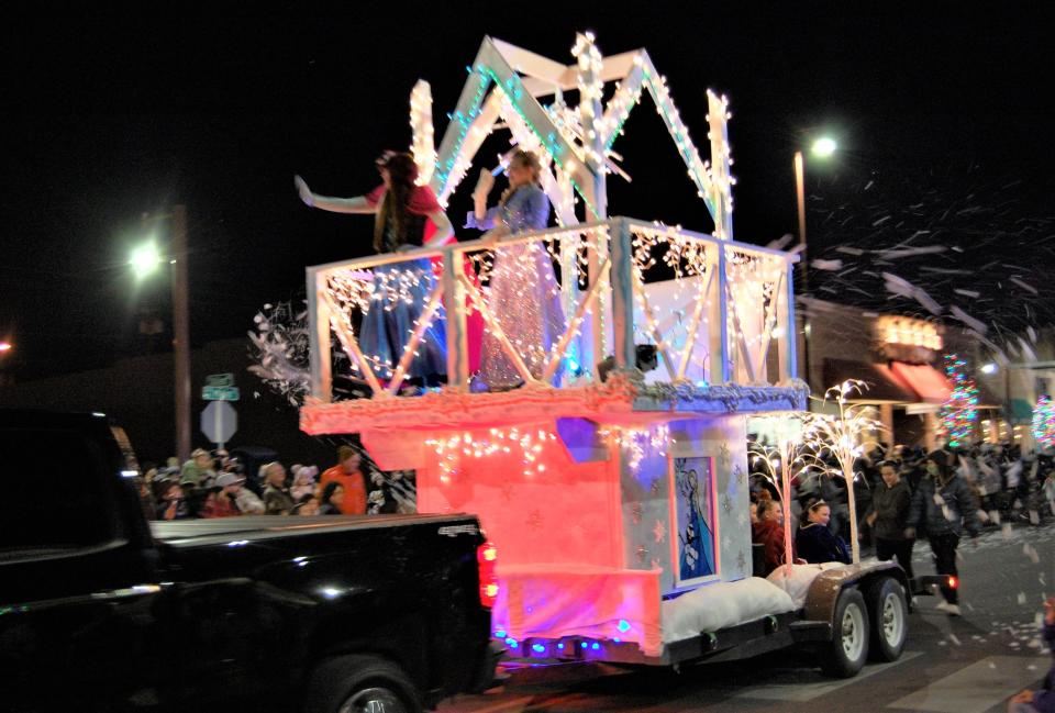 A float spraying fake snow is towed down Main Street through downtown Farmington on Dec. 2, 2021 during the annual Christmas Parade.