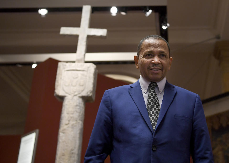 Andreas B.D. Guibeb, ambassador for Namibia in Germany stands in front of the Cape Cross column at the German Historical Museum in Berlin, Germany, Friday, May 17, 2019. The column was taken to Germany in 1893 when the area was part of the German colonial empire, and today is on display in the German Historical Museum in Berlin. Germany’s culture minister says the country is returning to Namibia the centuries-old stone cross, even though it was originally of European origin, as a gesture of reconciliation. (Britta Pedersen/dpa via AP)