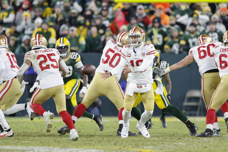 San Francisco 49ers quarterback Jimmy Garoppolo (10) pitches the ball during an NFL divisional playoff football game against the Green Bay Packer, Saturday, Jan 22. 2022, in Green Bay, Wis. (AP Photo/Jeffrey Phelps)