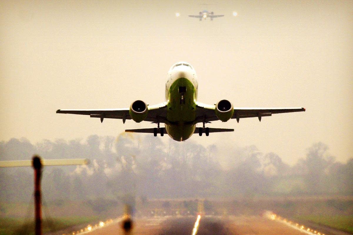 A plane takes off from the runway at Edinburgh Airport