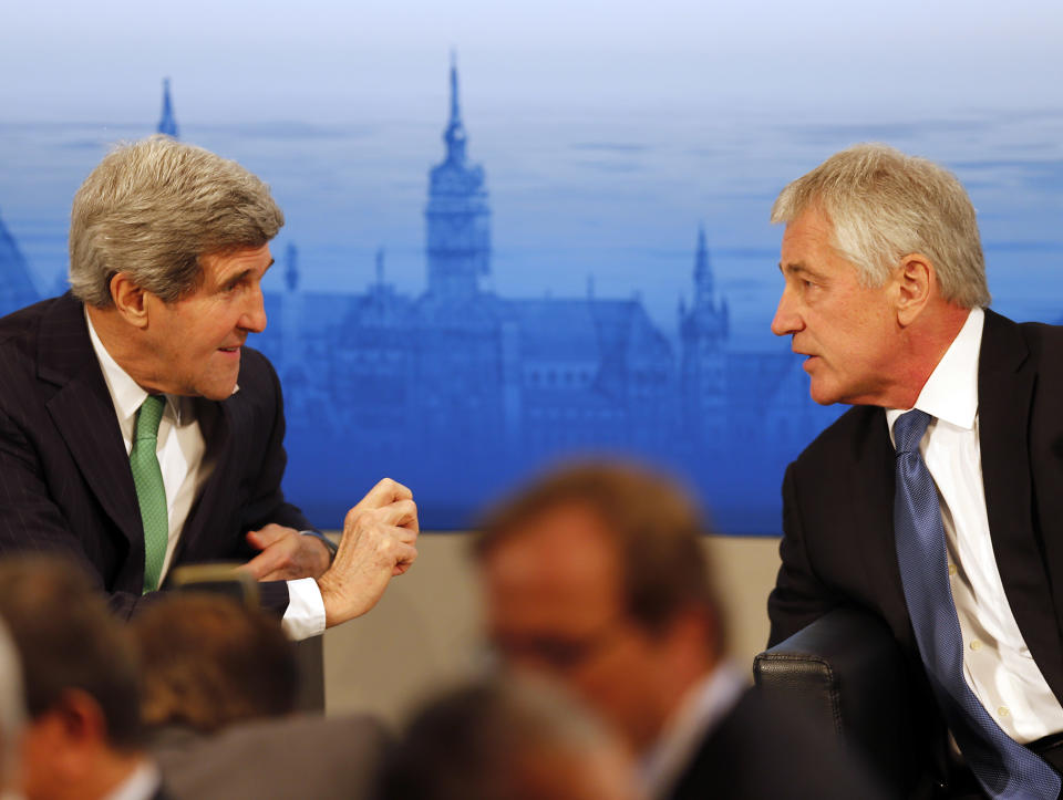 US Secretary of State John Kerry , left, and US Secretary of Defense, Chuck Hagel chat during the 50th Security Conference in Munich, Germany, Saturday, Feb. 1, 2014. The conference on security policy takes place from Jan.31,2014 until Feb. 2, 2014. (AP Photo/Frank Augstein)