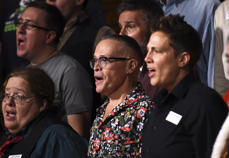 Rich Valdez, center, sings during a Christmas show rehearsal in Colorado Springs, Colo., on Wednesday, Nov. 30, 2022. The Out Loud Colorado Springs Men's Chorus has taken an active role in the healing process after a Nov. 19 attack killed five people at an LGBTQ nightclub in Colorado Springs. (AP Photo/Thomas Peipert)