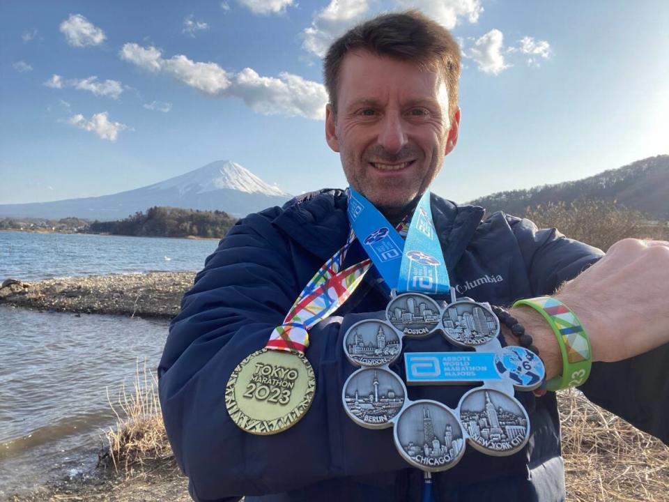 Marc Rodrigue of Timmins, Ont., displays medals from six marathons around the world, including his latest from Tokyo. (Submitted by Marc Rodrigue - image credit)