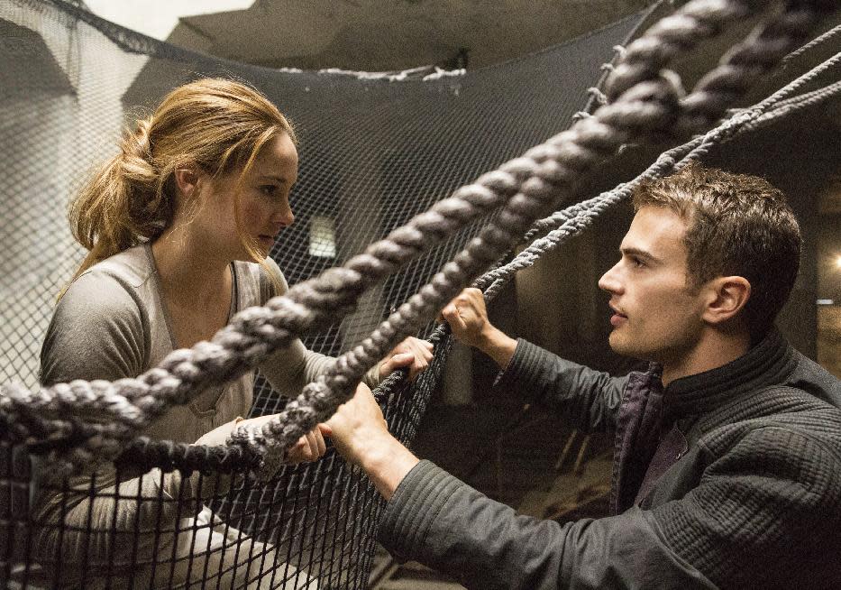 This image released by Summit Entertainment shows Shailene Woodley, left, and Theo James in a scene from "Divergent." (AP Photo/Summit Entertainment, Jaap Buitendijk)