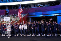 <p>Business on top, party on the bottom! Team USA, <a href="https://people.com/style/caroline-marks-team-usa-ralph-lauren-opening-ceremony-uniforms/" rel="nofollow noopener" target="_blank" data-ylk="slk:dressed by Ralph Lauren;elm:context_link;itc:0;sec:content-canvas" class="link ">dressed by Ralph Lauren</a>, wore dark denim pants, striped shirts and blazers to the opening ceremony. </p>