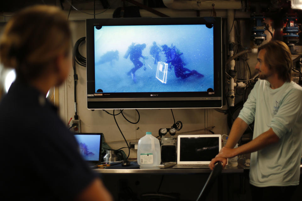 Researchers and crew aboard the NOAA Ship Nancy Foster watch footage of divers working at Gray's Reef, about 20 miles off the coast of Georgia on Wednesday, Aug. 4, 2019. (AP Photo/Robert F. Bukaty)