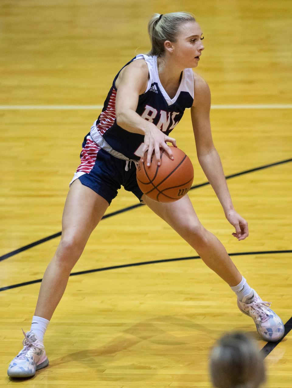 North Lawrence's Chloe Spreen (2) backs up to restart the offense against Gibson Southern during the North Basketball Showcase at North High School Friday night, Dec. 2, 2022.