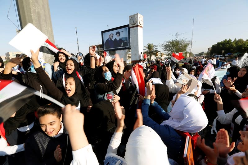 School students chant slogans as they take part in ongoing anti-government protests in Baghdad