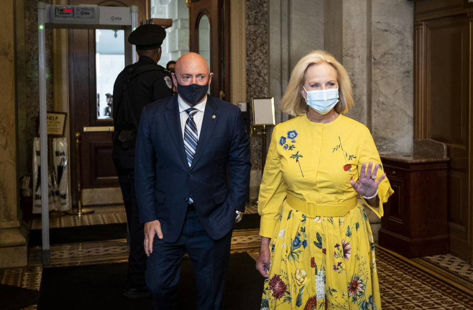 Sen. Mark Kelly escorts Cindy McCain into the Capitol as his guest for his maiden speech on the Senate floor on Aug. 4. (Bill Clark / CQ-Roll Call, Inc via Getty Images file)