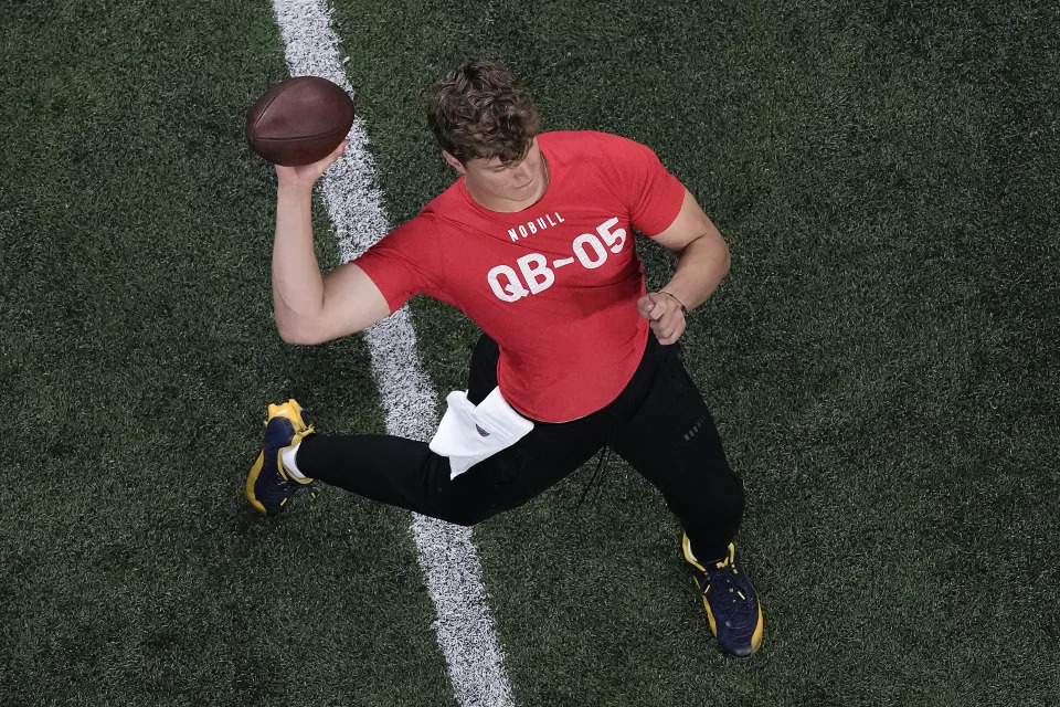 Michigan quarterback J.J. McCarthy passes during the NFL football scouting combine, Saturday, March 2, 2024, in Indianapolis. (AP Photo/Charlie Riedel)