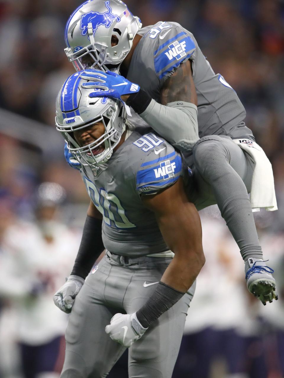 Detroit Lions' Trey Flowers (90) celebrates his sack with Tavon Wilson in the second half against the Chicago Bears at Ford Field on Nov. 28, 2019.