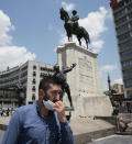 A man wearing a face mask to protect against the spread of coronavirus, walks in the city's historical part of Ulus with a statue of Turkey's founder Mustafa Kemal Ataturk in the background, in Ankara, Turkey, Thursday, June 18, 2020. Turkish authorities have made the wearing of masks mandatory in three major cities to curb the spread of COVID-19 following an uptick in confirmed cases since the reopening of many businesses.(AP Photo/Burhan Ozbilici)