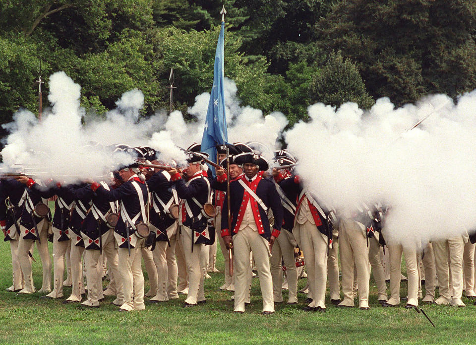 FILE — Re-enactors portraying members of the American forces during the Revolutionary War fire their rifles during a re-enactment celebrating the 225th anniversary of the Battle of Brooklyn, Aug. 18, 2001. Some historical battle re-enactors in New York are holding their musket fire because of worries over the state's new gun law that declares parks, government property and a long list of other places off limits to guns beginning in Sept. 2022. (AP Photo/Patrick M. Reed, File)