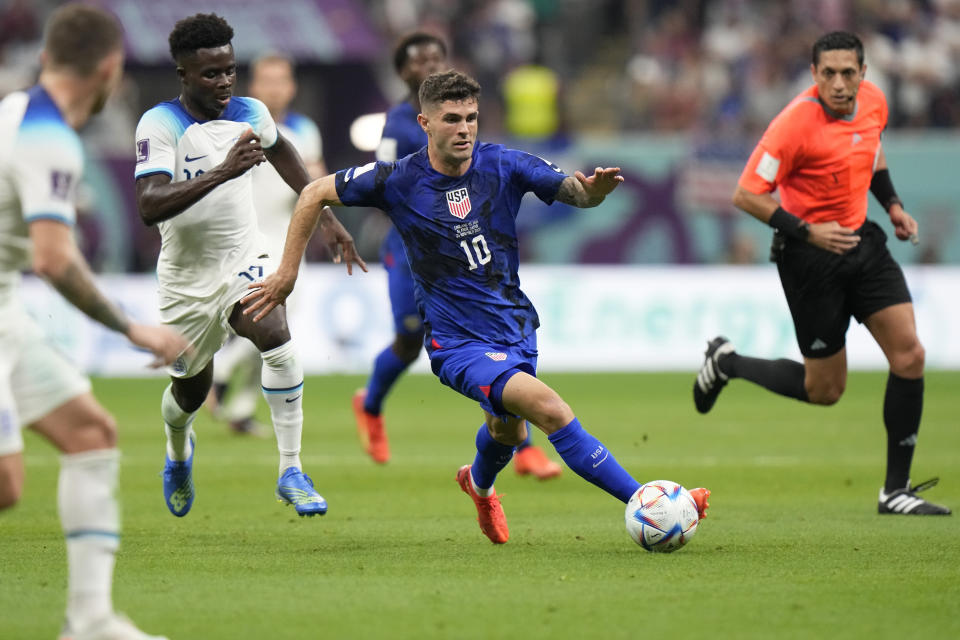 Christian Pulisic of the United States runs with the ball during the World Cup group B soccer match between England and The United States, at the Al Bayt Stadium in Al Khor , Qatar, Friday, Nov. 25, 2022. (AP Photo/Luca Bruno)