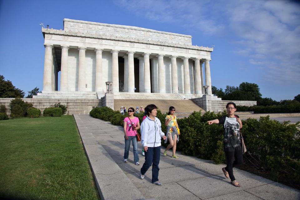 Visitors leave the Lincoln Memorial in Washington, Friday, July 26, 2013, after the U.S. Park Police closed it off after someone splattered green paint on the statue and the floor area of the memorial. Police say the apparent vandalism was discovered early Friday morning. No words, letters or symbols were visible in the paint. (AP Photo/J. Scott Applewhite)