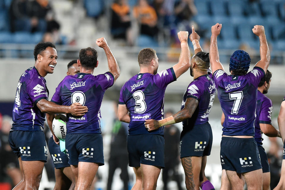 Cameron Smith and the Storm celebrate scoring a try.