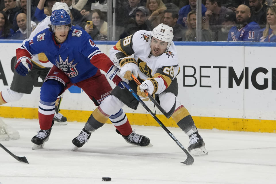 New York Rangers defenseman Braden Schneider (4) defends against Vegas Golden Knights left wing William Carrier (28) during the second period of an NHL hockey game Friday, Jan. 27, 2023, at Madison Square Garden in New York. (AP Photo/Mary Altaffer)