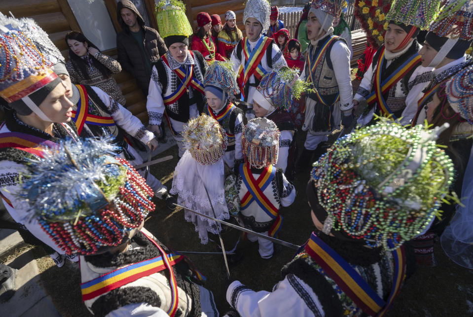 Participants, dressed in traditional costumes, dance while celebrating the Malanka festival in the village of Krasnoilsk, Ukraine, Friday, Jan. 14, 2022. Dressed as goats, bears, oxen and cranes, many Ukrainians rang in the new year last week in the colorful rituals of the Malanka holiday. Malanka, which draws on pagan folk tales, marks the new year according to the Julian calendar, meaning it falls on Jan. 13-14. In the festivities, celebrants go from house to house, where the dwellers offer them food. (AP Photo/Ethan Swope)