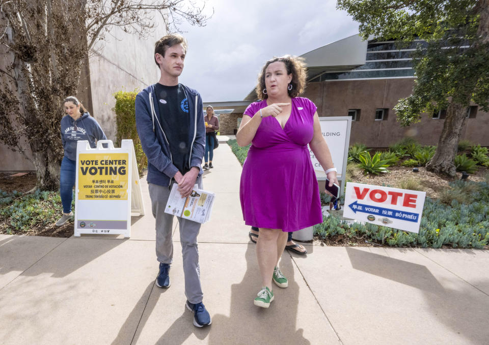 Luke Hoffman, 18, left, walks with his mother, U.S. Senate candidate and U.S. Rep. Katie Porter, as they leave the vote center at the University Hills Community Center in Irvine, Calif., after voting, Saturday, March 2, 2024. (Mark Rightmire/The Orange County Register via AP)