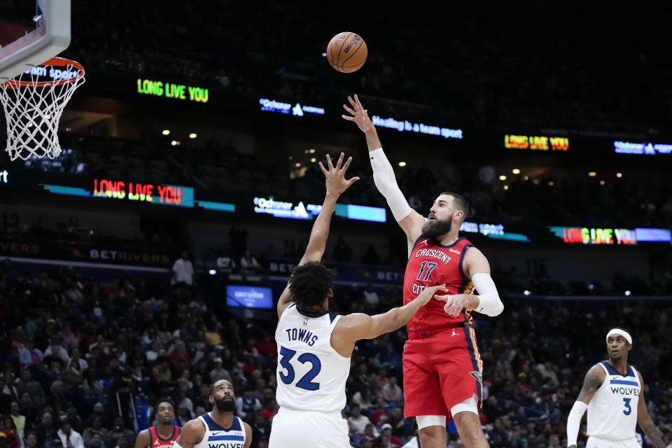 New Orleans Pelicans center Jonas Valanciunas (17) shoots over Minnesota Timberwolves center Karl-Anthony Towns (32) in the first half of an NBA basketball game in New Orleans, Monday, Dec. 11, 2023. (AP Photo/Gerald Herbert)