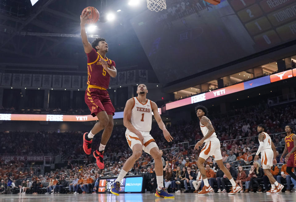 Iowa State guard Curtis Jones (5) drives to the basket past Texas forward Dylan Disu (1) during the first half of an NCAA college basketball game Tuesday, Feb. 6, 2024, in Austin, Texas. (AP Photo/Eric Gay)