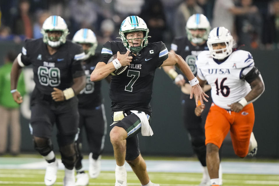 Tulane quarterback Michael Pratt (7) scrambles on a 26-yard carry in the second half of an NCAA college football game against UTSA in New Orleans, Friday, Nov. 24, 2023. Tulane won 29-16. (AP Photo/Gerald Herbert)