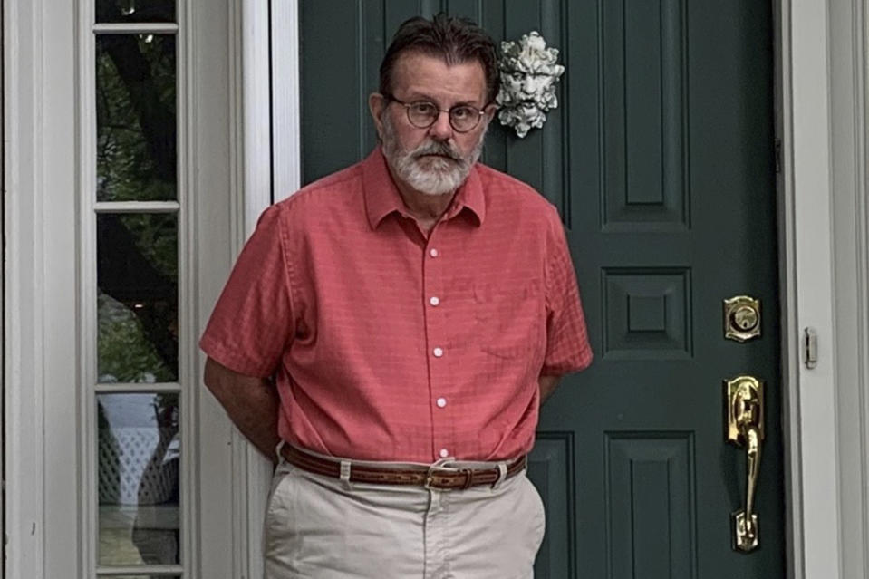 Richard Dayton stands in front of his house as he poses for a photograph, Friday, July 17, 2020, in Columbus, Ohio. State and local election officials across the country are trying to recruit younger workers to staff polling places on Election Day in November. The effort is driven by concern that many traditional poll workers will be too worried about catching the coronavirus to show up. (AP Photo/Farnoush Amiri)