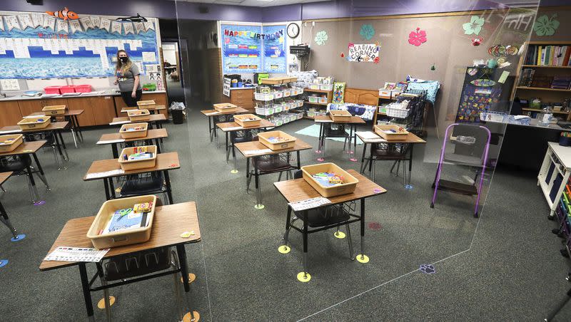 First grade teacher Jamie Greenwood looks at a large sheet of clear plastic that hangs from the ceiling in her classroom at Westvale Elementary School in West Jordan on Aug. 19, 2020. Now that the pandemic is over, how will schools adjust again?