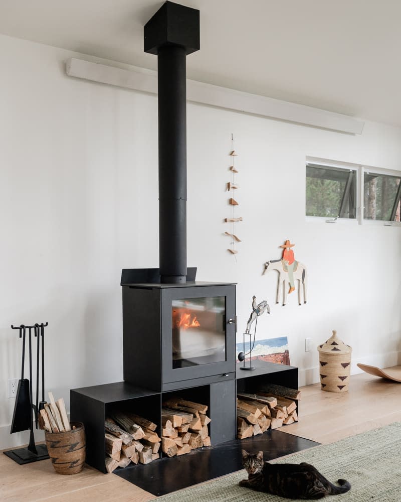 Wood stove in light filled living room.