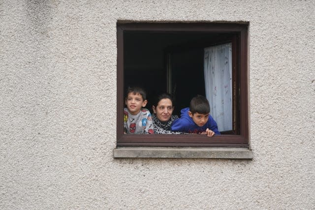 People look out of a window at flood water in Brechin, Scotland