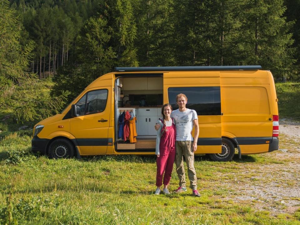 Charlie Low and Dale Comley standing outside of their van home.