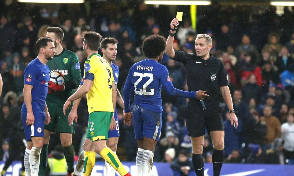 Pressure moment: Chelsea’s Willian is shown a yellow card by Graham Scott for diving in the penalty area.