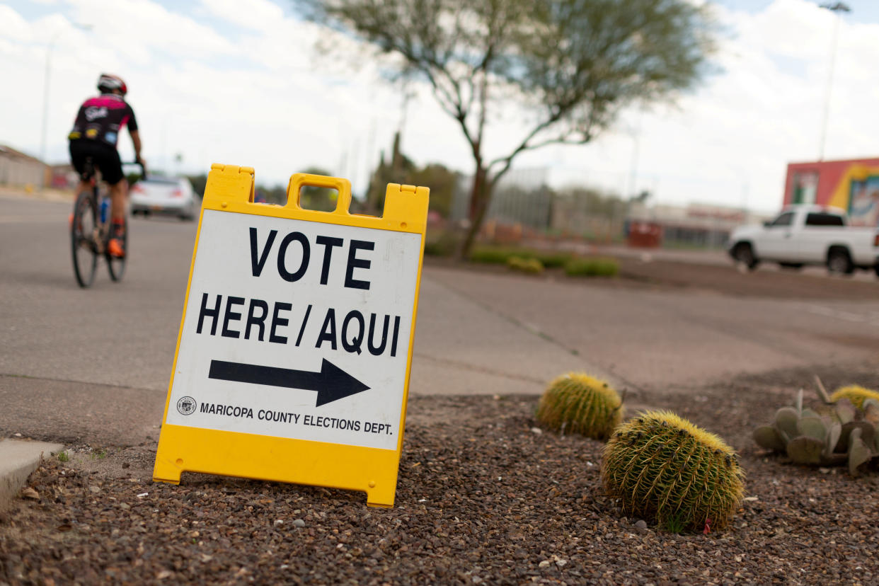 A sign points voters to a voting center for the Democratic primary in Sun City, Arizona, U.S., March 17, 2020.  (Cheney Orr/Reuters)