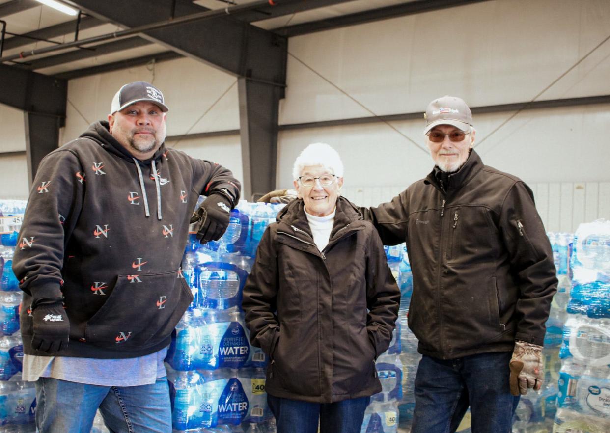 From left to right: Mike Tyner, of Doug Bradley Trucking Inc, and Rosemary Mai and Kenneth Cochran of the Granny Brigade stand in front of 25 pallets of bottled water collected as part of the water drive March 3. The water will be delivered to East Palestine, Ohio, Monday.