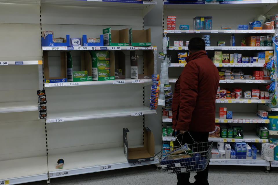 Empty shelves are seen at a Tesco store, in London, Friday, March 13, 2020. For most people, the new coronavirus causes only mild or moderate symptoms, such as fever and cough. For some, especially older adults and people with existing health problems, it can cause more severe illness, including pneumonia.(AP Photo/Alberto Pezzali)