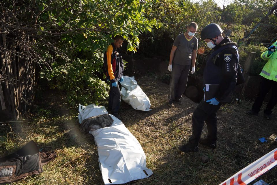 Ukrainian police work during the exhumation of unidentified bodies of people allegedly killed by Russian troops in the village of Grakovo, recently freed by the Ukrainian army, in the Kharkiv region, September 9, 2022. / Credit: Andrii Marienko/AP