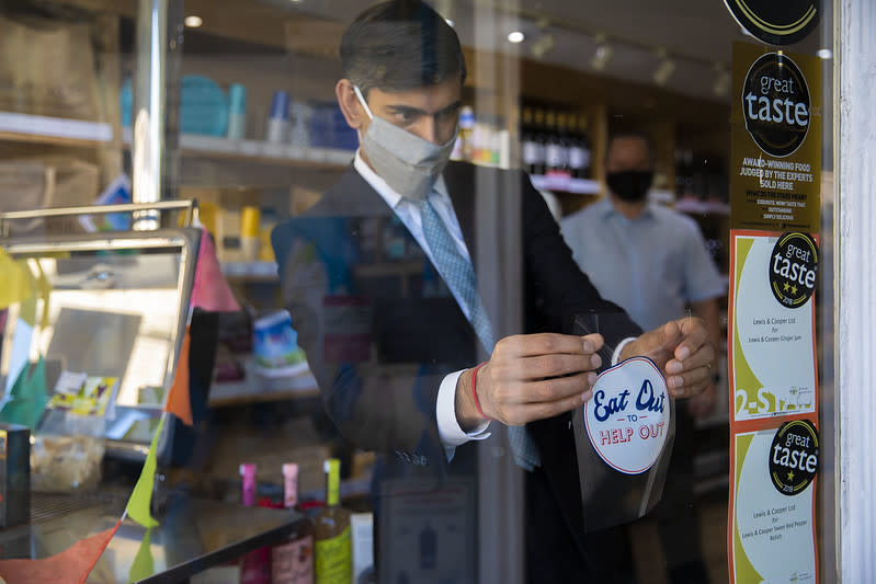 The Chancellor Rishi Sunak helps to advertise Eat Out To Help Out by putting up stickers in participating restaurants and cafes in Northallerton