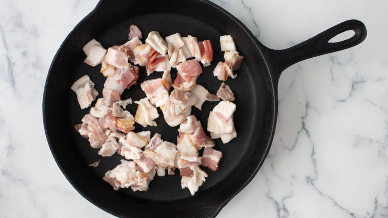 raw bacon in frying pan