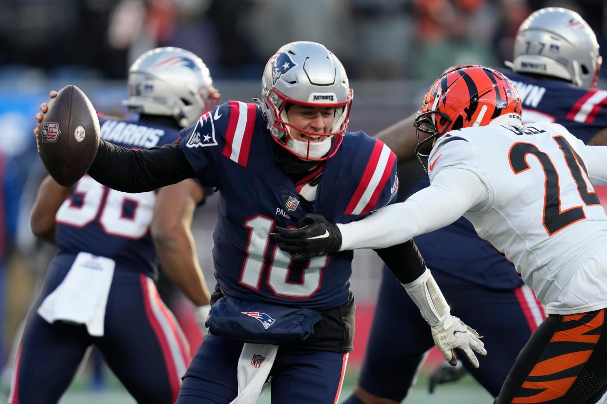 New England Patriots quarterback Mac Jones (10) is sacked by Cincinnati Bengals safety Vonn Bell (24) during the second half of an NFL football game, Saturday, Dec. 24, 2022, in Foxborough, Mass. (AP Photo/Charles Krupa)