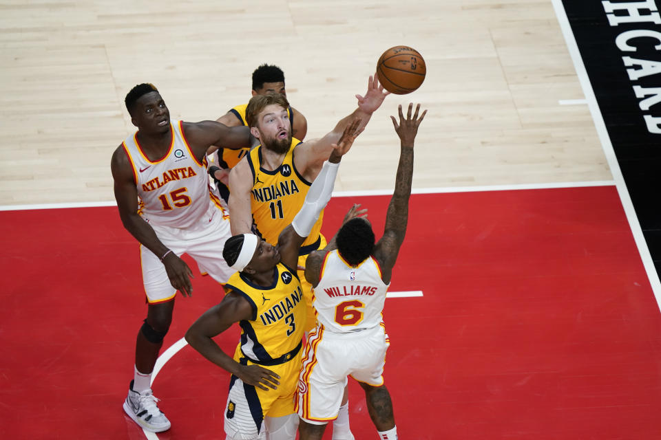 Indiana Pacers forward Domantas Sabonis (11) goes for the rebound against Atlanta Hawks guard Lou Williams (6) during the second half of an NBA basketball game on Sunday, April 18, 2021, in Atlanta. (AP Photo/Brynn Anderson)