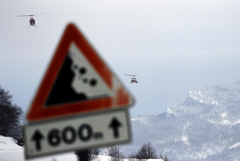 Rescue helicopters approach the area in Rigopiano