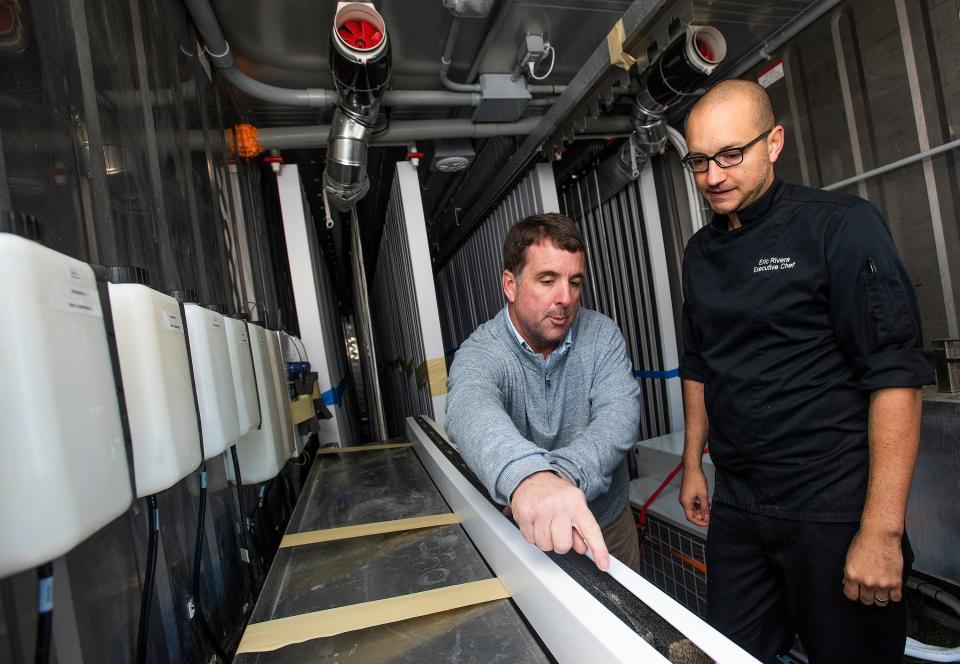 Vintage Year owner Jud Blount, left, and Executive Chef Eric Rivera show their new hydroponic container garden set up to grow fresh vegetables for the Vintage Year restaurants in Montgomery on Nov. 19, 2019.