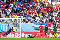 Cameroon's goalkeeper Andre Onana, left, saves a ball shot by Switzerland's Ruben Vargas, center right, during the World Cup group G soccer match between Switzerland and Cameroon, at the Al Janoub Stadium in Al Wakrah, Qatar, Thursday, Nov. 24, 2022. (AP Photo/Petr Josek)