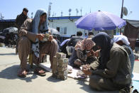 Afghan money changers wait for customers at a currency exchange market in Kabul, Afghanistan, Monday, April 22, 2024. (AP Photo/Siddiqullah Alizai)