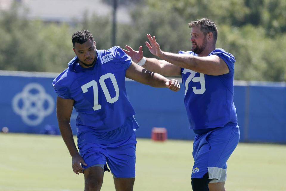 Rams offensive tackle Rob Havenstein (79) pushes Joe Noteboom (70) during drills.